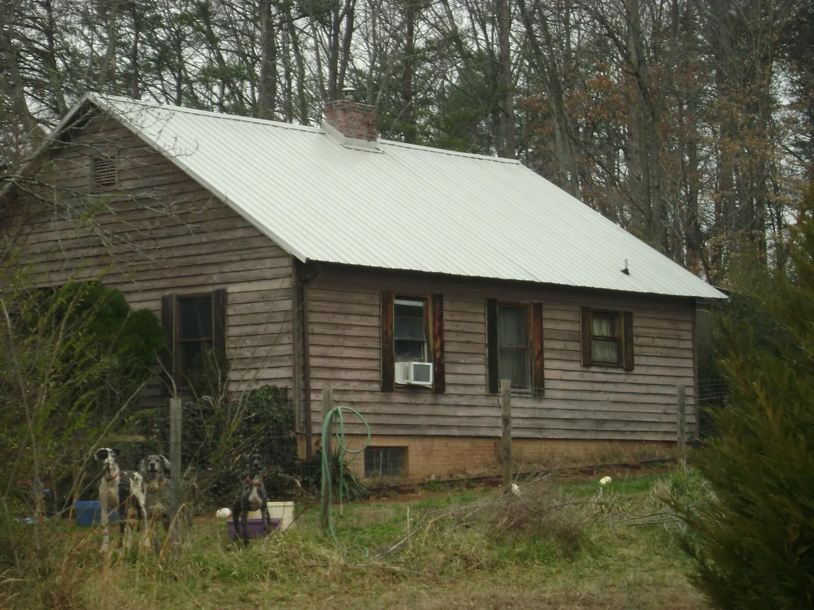 White metal roof on an old wood sided farmhouse, from a Asphalt Shingle Roof Repair job in Carrier